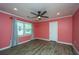 Spacious bedroom with salmon colored walls, ceiling fan, vinyl floor and bright, natural light at 881 Evans Rd, Charleston, SC 29412
