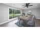Bright dining area with large windows, modern furniture, and hardwood floors at 881 Evans Rd, Charleston, SC 29412