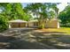Spacious driveway leads to a two-car garage with a charming single-story home at 881 Evans Rd, Charleston, SC 29412