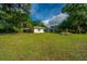 Charming single-story home featuring a huge front yard and beautiful surrounding trees at 881 Evans Rd, Charleston, SC 29412