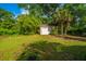 Detached garage in a well-maintained backyard with a mix of grass and sandy areas at 881 Evans Rd, Charleston, SC 29412