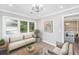Bright sitting room with large windows, comfortable seating, and views to the backyard at 881 Evans Rd, Charleston, SC 29412