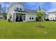 A screened porch enhances this backyard with a young tree adding beauty at 953 Dusk Dr, Summerville, SC 29486