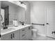 Bright bathroom featuring a double vanity with white cabinets and black hardware, plus a toilet with a safety bar at 953 Dusk Dr, Summerville, SC 29486