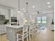 Bright, open kitchen featuring an island with seating, pendant lighting, and stainless steel appliances at 953 Dusk Dr, Summerville, SC 29486