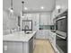 Modern kitchen with white cabinets, stainless steel appliances, a center island and stylish backsplash at 953 Dusk Dr, Summerville, SC 29486