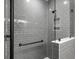 Modern shower features gray subway tiles, a glass enclosure, and a convenient built-in niche for toiletries at 953 Dusk Dr, Summerville, SC 29486
