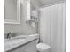A clean bathroom features a marble countertop vanity, mirrored cabinet, and shower with a white curtain at 1050 Marsh Court Ln, Mount Pleasant, SC 29464