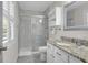 Bright bathroom with glass-enclosed shower, granite countertops, and white cabinets at 1050 Marsh Court Ln, Mount Pleasant, SC 29464