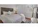 A comfortable bedroom features a queen bed, shuttered windows, wood floors, and neutral walls at 1050 Marsh Court Ln, Mount Pleasant, SC 29464
