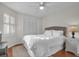This bedroom features hardwood floors, ceiling fan, shuttered windows, and neutral walls for a light, airy space at 1050 Marsh Court Ln, Mount Pleasant, SC 29464