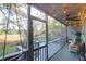 The screened-in deck features comfortable seating and an outdoor view of the surrounding green trees at 1050 Marsh Court Ln, Mount Pleasant, SC 29464