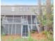 Rear elevation view of home featuring a multi-tiered deck system and exterior stairs at 1050 Marsh Court Ln, Mount Pleasant, SC 29464
