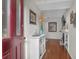 Welcoming foyer with bright lighting, white cabinet, elegant decor, and hardwood floors at 1050 Marsh Court Ln, Mount Pleasant, SC 29464