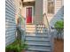Inviting front entrance with a bright red door, white steps, and manicured landscaping at 1050 Marsh Court Ln, Mount Pleasant, SC 29464