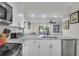 Open kitchen featuring marble countertops, white cabinets, and stainless steel appliances overlooking the living space at 1050 Marsh Court Ln, Mount Pleasant, SC 29464