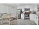 Bright kitchen with stainless steel appliances, white cabinetry, and dining table at 1050 Marsh Court Ln, Mount Pleasant, SC 29464
