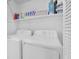 Bright laundry room with white washer and dryer and storage shelves at 1050 Marsh Court Ln, Mount Pleasant, SC 29464
