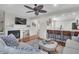 Cozy living room with a fireplace and mounted TV, flowing into a kitchen with bar seating at 1050 Marsh Court Ln, Mount Pleasant, SC 29464
