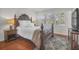 Comfortable bedroom featuring a king bed, wood floors, plantation shutters and a flat screen TV at 1050 Marsh Court Ln, Mount Pleasant, SC 29464