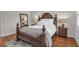 A bright main bedroom showcases a large, carved wood bed frame with decorative posts, lamps, and a stylish area rug at 1050 Marsh Court Ln, Mount Pleasant, SC 29464