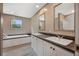 Bathroom featuring double vanity, bathtub and large mirror with plenty of light at 106 Swanson Dr, Summerville, SC 29483