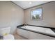 Bright bathroom featuring a modern soaking tub with sleek fixtures and a window at 106 Swanson Dr, Summerville, SC 29483