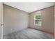 Bedroom with light vinyl flooring, featuring a window for natural light and a built-in closet at 106 Swanson Dr, Summerville, SC 29483