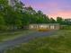 Inviting home exterior with a cozy front porch and a long, paved driveway at 106 Swanson Dr, Summerville, SC 29483