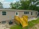 Charming home exterior featuring a rear wooden deck, well-lit windows, and an air conditioning unit at 106 Swanson Dr, Summerville, SC 29483