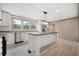 Bright, open kitchen with stainless appliances, center island with dark countertop, and modern lighting at 106 Swanson Dr, Summerville, SC 29483