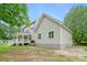 View of the back of the home featuring a white porch with a large tree in the backyard at 1076 Williams Rd, Charleston, SC 29412