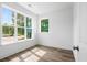 Sunlit bedroom with hardwood floors and large windows offering scenic views at 1076 Williams Rd, Charleston, SC 29412