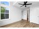A bright bedroom features a ceiling fan, natural light, and access to an en suite bathroom and closet at 1076 Williams Rd, Charleston, SC 29412