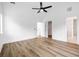 A bright bedroom features wood-look floors, a ceiling fan, and neutral walls with views to the bathroom and closet at 1076 Williams Rd, Charleston, SC 29412