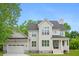 New construction with gray siding, black roof, attached garage, and covered front porch at 1076 Williams Rd, Charleston, SC 29412