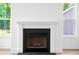 Close up view of modern fireplace with white mantle and black hearth at 1076 Williams Rd, Charleston, SC 29412