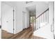Bright entryway featuring hardwood floors, white walls, and wooden staircase at 1076 Williams Rd, Charleston, SC 29412