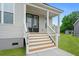 Inviting front porch with wooden stairs and white railings leading to the home's entrance at 1076 Williams Rd, Charleston, SC 29412