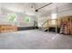 Spacious three-car garage with concrete floors, an unfinished ceiling, and exposed walls with two windows at 1076 Williams Rd, Charleston, SC 29412