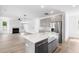 View of the kitchen island with sink, open to living room and fireplace at 1076 Williams Rd, Charleston, SC 29412