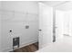 Laundry room with white walls, hardwood floors, and storage shelves at 1076 Williams Rd, Charleston, SC 29412