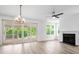 Spacious living room with hardwood floors, fireplace, and sliding glass doors to patio at 1076 Williams Rd, Charleston, SC 29412