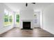 Bright living room featuring a fireplace, large windows, and modern wood floors at 1076 Williams Rd, Charleston, SC 29412