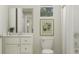 A tidy and well-lit bathroom featuring a sink vanity, toilet and walk-in shower at 1130 Darling St, Summerville, SC 29485