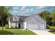 Charming single-story home featuring a two-car garage, well-manicured lawn, and inviting curb appeal at 1130 Darling St, Summerville, SC 29485