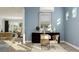 An inviting home office with natural light, desk, decorative items, and a glimpse into the adjacent living room at 1130 Darling St, Summerville, SC 29485