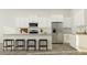 Modern kitchen with white cabinets, stainless steel appliances, granite countertops, and a breakfast bar with seating at 1130 Darling St, Summerville, SC 29485