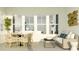 Relaxing outdoor patio with comfortable seating, a stylish table, and views of the home's interior at 1130 Darling St, Summerville, SC 29485