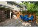 Cozy back deck featuring comfortable blue chairs, an outdoor storage box, and mature trees at 1166 Julian Clark Rd, Charleston, SC 29412